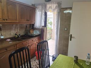 a kitchen with a sink and a table with chairs at Silence area 1 in north Athens in Acharnes