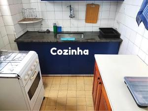 a kitchen with a colininian sign on a counter in a kitchen at Apartamento em Vitória capital do ES in Vitória