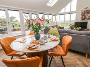 a living room with a table with food on it at Meadowside in Penzance