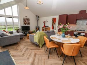 a kitchen and living room with a table and chairs at Meadowside in Penzance