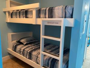 two bunk beds in a room with a bed at Laketown Wharf 1717 in Panama City Beach