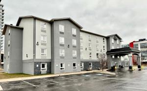 a large gray building with a parking lot at Quality Inn & Suites in Grimsby