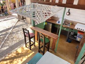 a kitchen with a table and two chairs and a counter at Posada Don Julio in Flores