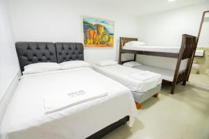 Postel nebo postele na pokoji v ubytování Hotel La Casona de Getsemani
