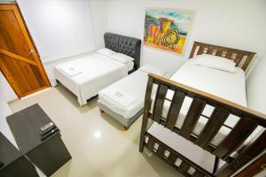 Postel nebo postele na pokoji v ubytování Hotel La Casona de Getsemani