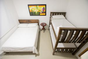 Postel nebo postele na pokoji v ubytování Hotel La Casona de Getsemani