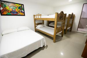 Postel nebo postele na pokoji v ubytování Hotel La Casona de Getsemani