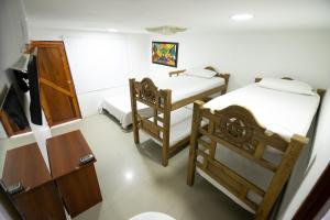 Postel nebo postele na pokoji v ubytování Hotel La Casona de Getsemani