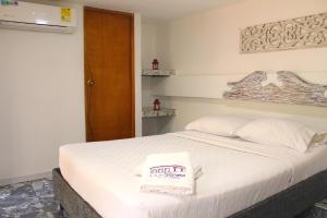 Postel nebo postele na pokoji v ubytování Hotel La Casona de Getsemani
