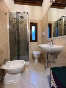 a bathroom with a sink and a toilet and a shower at Zero45 San Martino Apartment in Grosseto