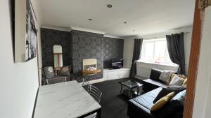 a living room with a couch and a table at Lovely One-Bedroom Condo With Indoor Fireplace in Sunderland