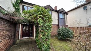 a brick house with ivy on the side of it at Lovely One-Bedroom Condo With Indoor Fireplace in Sunderland