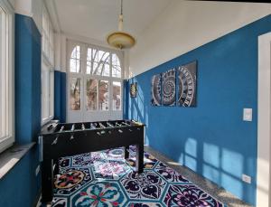 Habitación con paredes azules y mesa con suelo de mosaico. en Charysma - Jugendstil trifft Moderne, Schlafzimmer mit TV & Netflix, Parkplatz en Hameln