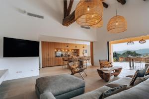 a living room with a couch and a tv at Villa Joia in Saint-Tropez