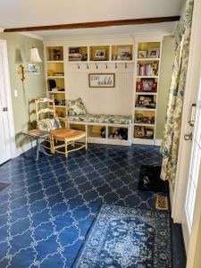 a living room with a blue floor and bookshelves at Waterfront Getaway in Wethersfield