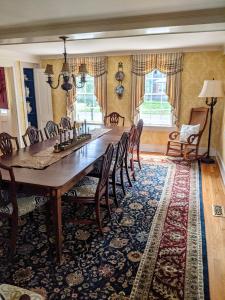 a dining room with a large wooden table and chairs at Waterfront Getaway in Wethersfield
