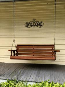 a bench hanging from a wall with a sign on it at Waterfront Getaway in Wethersfield