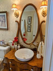 a bathroom with a sink and a large mirror at Waterfront Getaway in Wethersfield
