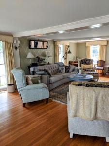 a living room with a couch and chairs at Waterfront Getaway in Wethersfield