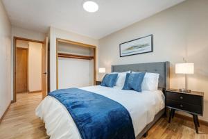 a bedroom with a large bed with blue pillows at The Goldmine in Kennewick