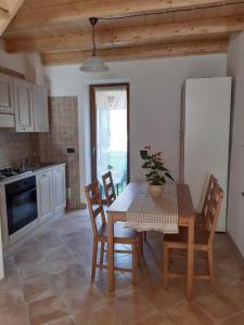 a kitchen with a table and chairs and a kitchen with a sink at Casa Ylenia in Borzonasca
