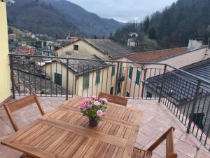 a wooden table and chairs on a balcony at Casa Ylenia in Borzonasca