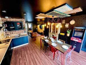 a kitchen with a table and chairs in a room at Artist Retro Disneyland Paris P3 in Coutevroult
