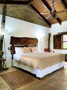 a bedroom with a large bed in a room at Hotel Hacienda San Lucas in Copán Ruinas