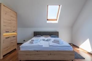 a bedroom with a large bed with a window at Familia Apartament na wzgórzu 3 z sauną i salą zabaw dla dzieci in Gdynia