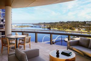 a balcony with a view of the water at The Ritz-Carlton, Perth in Perth