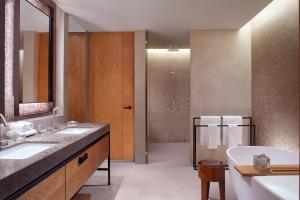 a bathroom with two sinks and a tub and a shower at The Ritz-Carlton, Perth in Perth