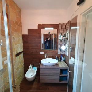 a bathroom with a sink and a mirror at Giancasavacanze in Alghero