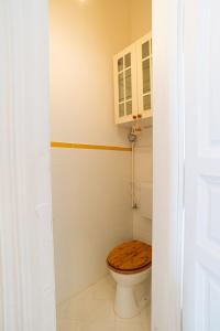 a bathroom with a toilet with a wooden seat at Terrace VuVu - Apartment with balcony in the heart of Budapest in Budapest