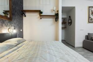 a bedroom with a large bed and a couch at Loft Deluxe Magnolia - Ovindoli in Ovindoli