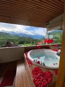 a jacuzzi tub in a room with a view at Mercedes Lodge in San Ramón