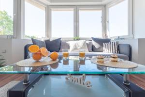 a living room with a glass coffee table with oranges on it at Familia Apartament na wzgórzu 2 z sauną i salą zabaw dla dzieci in Gdynia