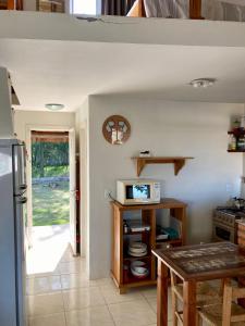a kitchen with a table and a counter top at Villas da Jagua in Jaguaruna