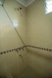 a bathroom with a shower with a glass door at Las Moras Del Manantial in Termas de Río Hondo