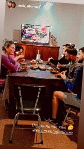 a group of people sitting around a table eating food at El Convento de Tilcara in Tilcara