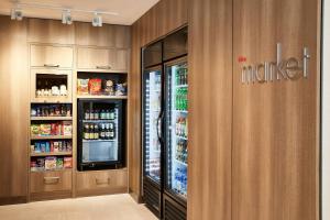 a kitchen with a refrigerator and some drinks at Residence Inn By Marriott Dallas By The Galleria in Dallas