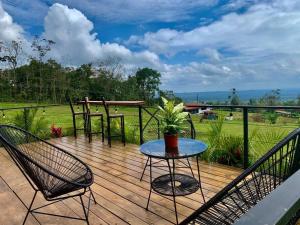a wooden deck with two chairs and a table with a potted plant at Villa Aura in Fortuna +29 photos