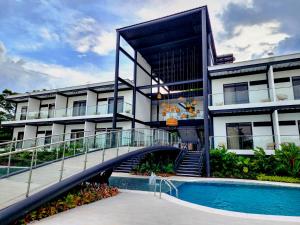 a building with a bridge over a swimming pool at Hotel Capri Doradal in Doradal +50 photos
