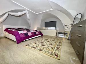 a bedroom with a bed and a rug at Living Dalia in Carovigno