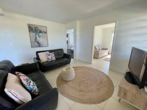 a living room with a couch and a table at The Lucinda White House in Lucinda