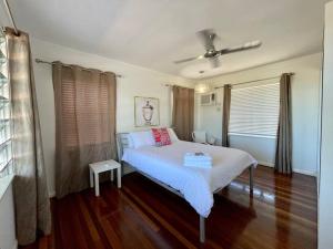 a bedroom with a bed with white sheets and red pillows at The Lucinda White House in Lucinda