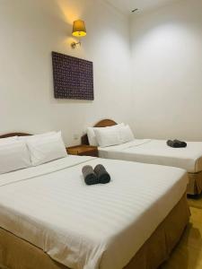 Postel nebo postele na pokoji v ubytování ANGGERIK IMPIAN HOTEL -Best for Travellers at Kuala Berang