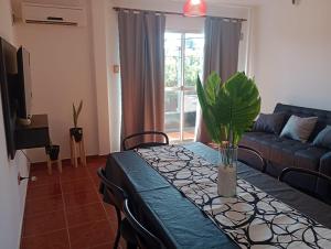 a living room with a table and a couch at Departamentos La Perón in Villa Mercedes