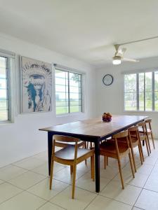 a dining room with a wooden table and chairs at The Lucinda White House in Lucinda