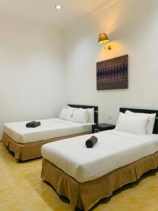 Postel nebo postele na pokoji v ubytování ANGGERIK IMPIAN HOTEL -Best for Travellers at Kuala Berang