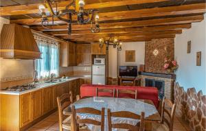 a kitchen with a table and a dining room at Amazing Home In Mecina Bombarn With Wifi in Mecina Bombarón